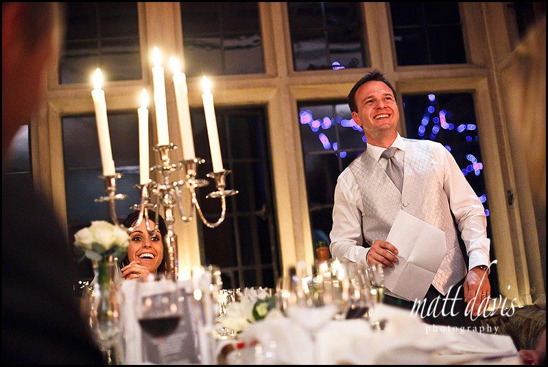 Bibury-court-wedding-photos060 groom smiles during speeches at Speeches at Bibury Court