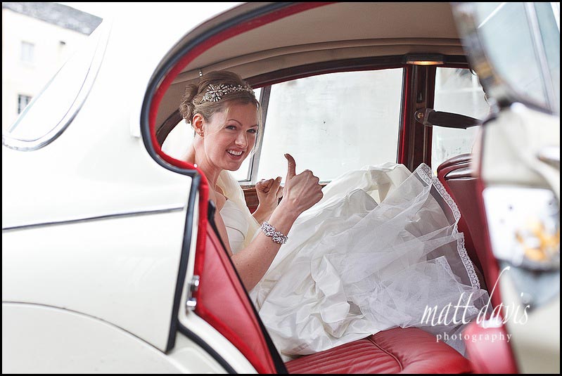 Bride in vintage wedding car