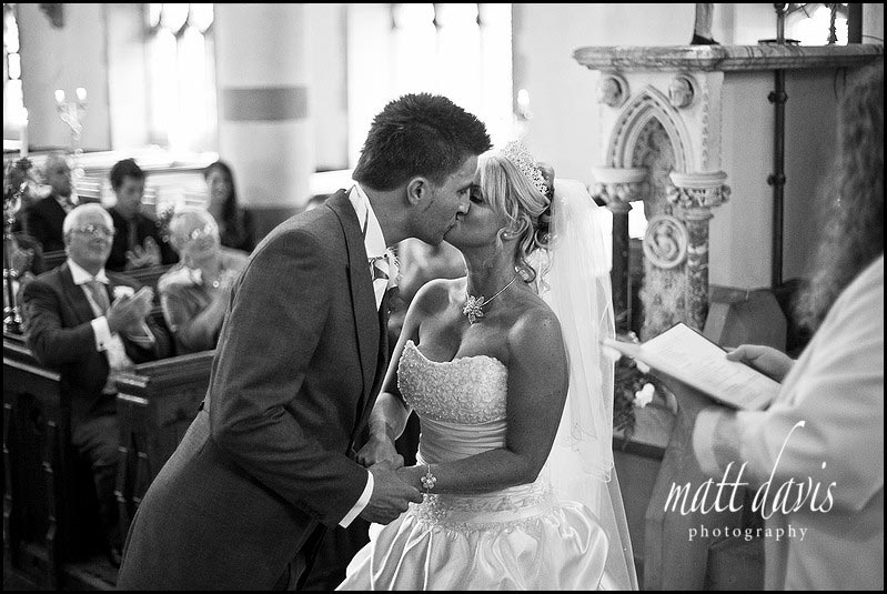 wedding kiss at St. Peter's Church Clearwell