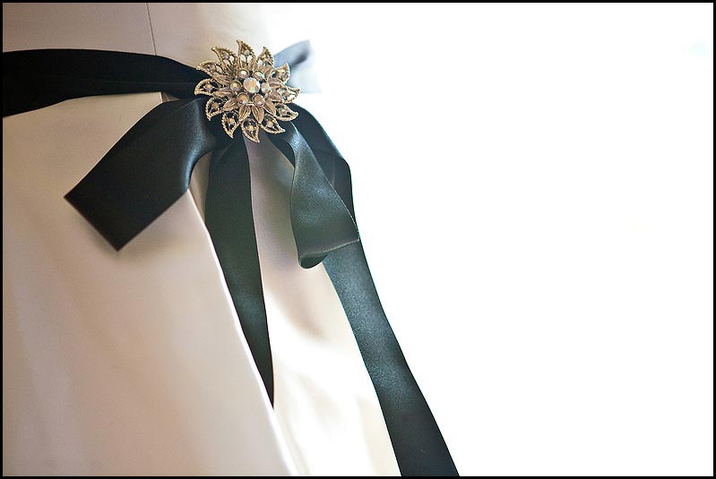 black sash on wedding dress with broach