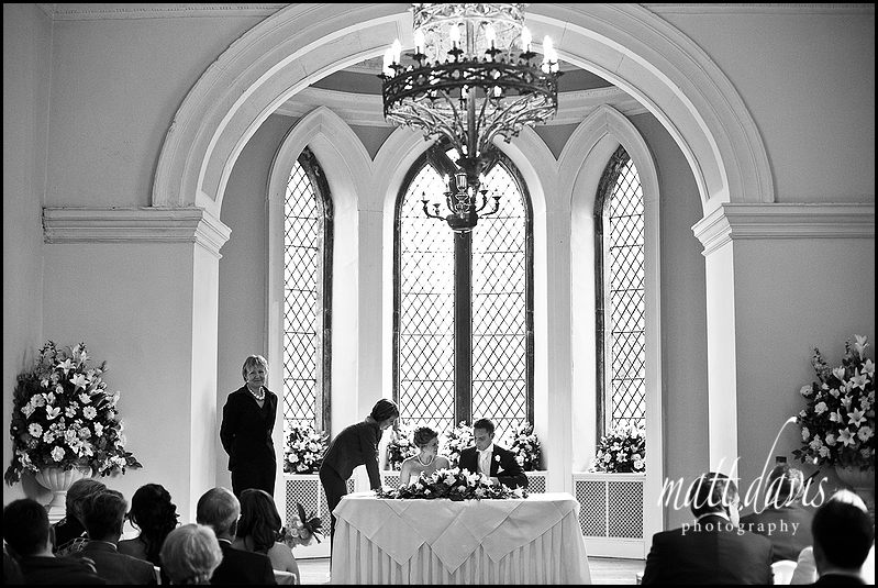 Signing the register at Clearwell Castle wedding venue