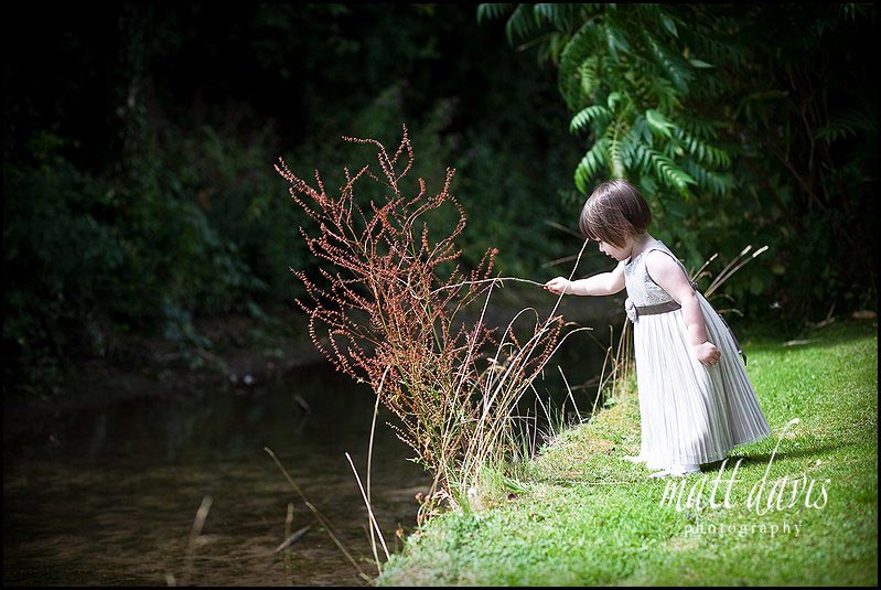 Bridesmaid playing in stream at a wedding