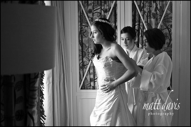 bride getting into wedding dress at Manor House Hotel