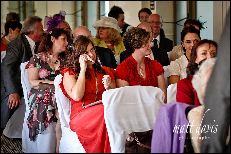 guests crying at wedding in red dress