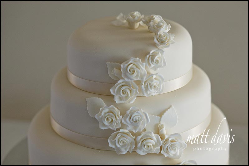 ivory wedding cake with small roses detail