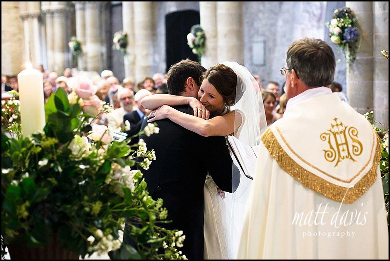 Wedding photos in church of couple kissing