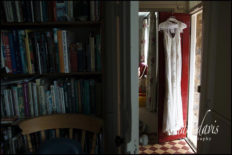 Vintage weeding dress hung on door