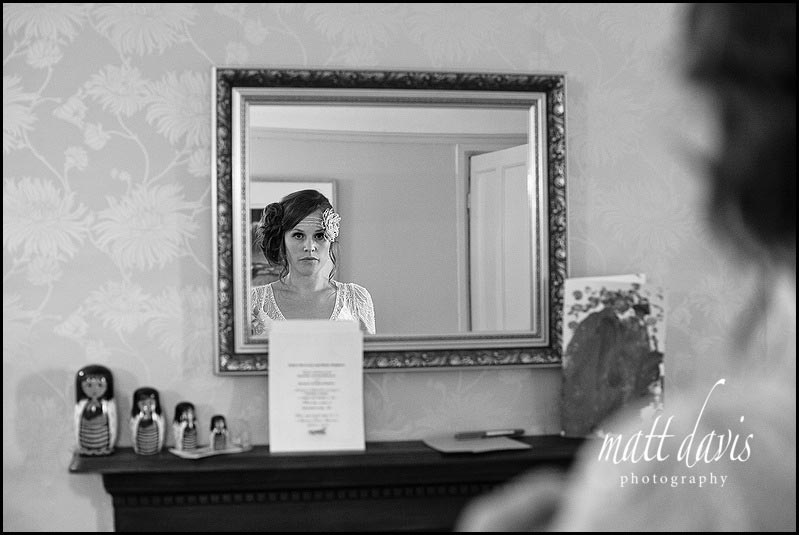 Vintage bride looking in mirror