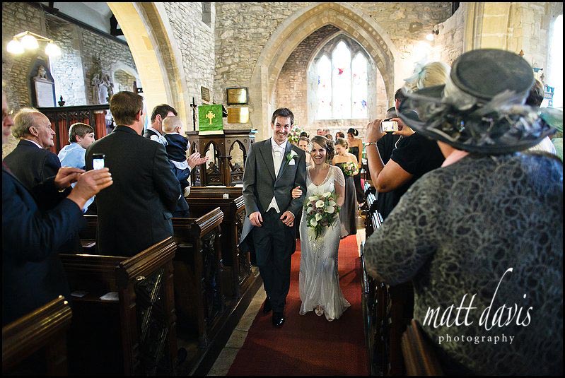 Bride and groom leaving Crudwell Church
