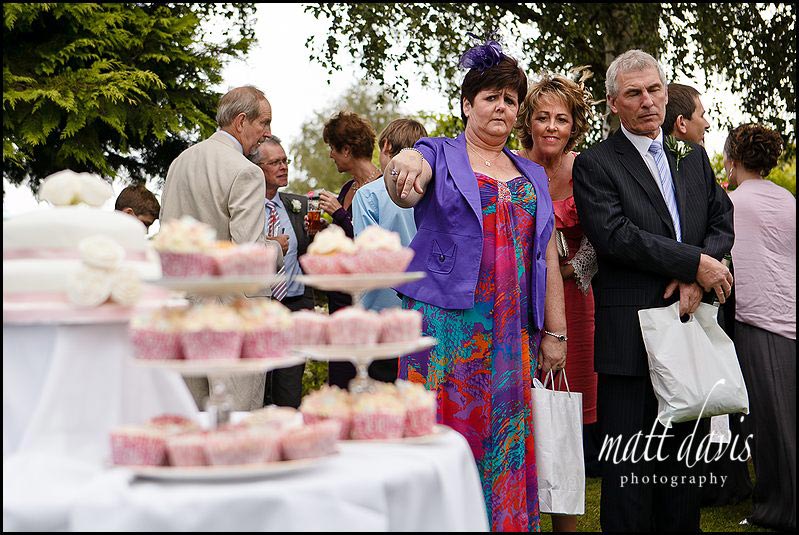 Wedding guests looking at vintage wedding cake
