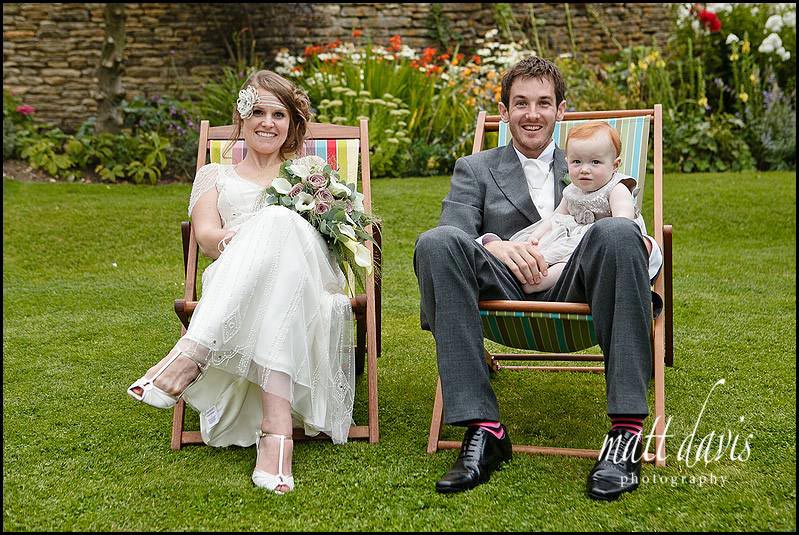 Wedding photo of couple sat in deck chairs