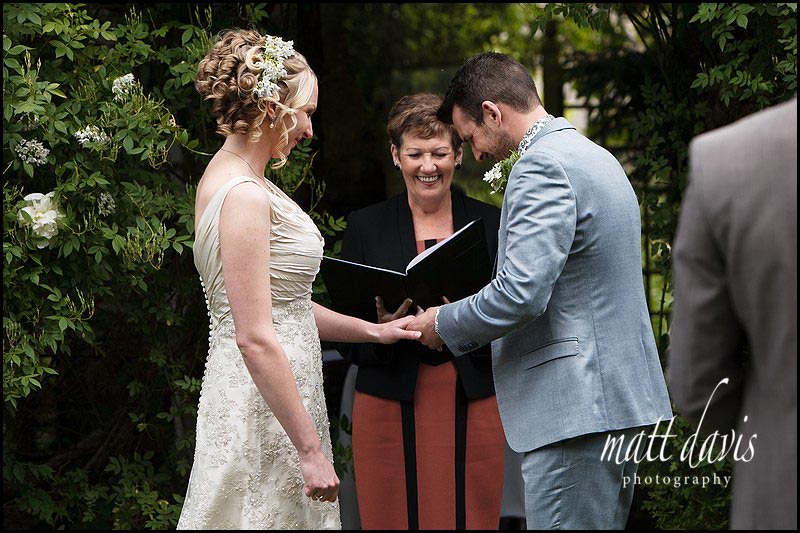 wedding ceremony outdoors at Friars Court under the rose arbor 