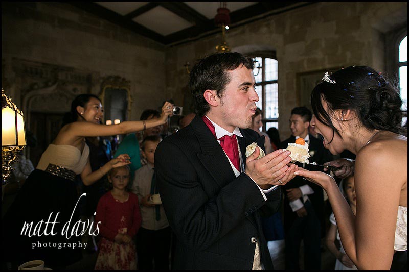 bride and groom eating wedding cake cutting at Berkeley Castle 