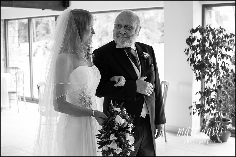 Father of the bride smiling at bride