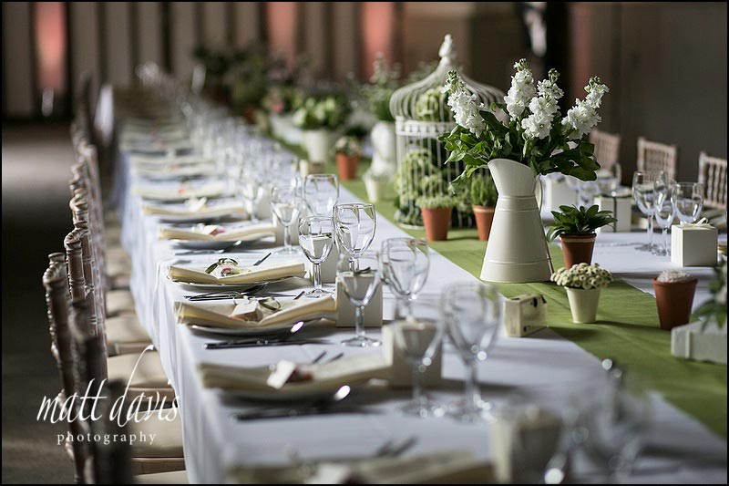 Long table layouts for weddings with flowers and bird cages
