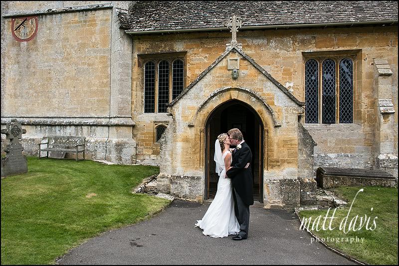 Wedding-photography-Berkeley-Castle-044 wedding couple kissing outside St Andrew's church near Cheltenham