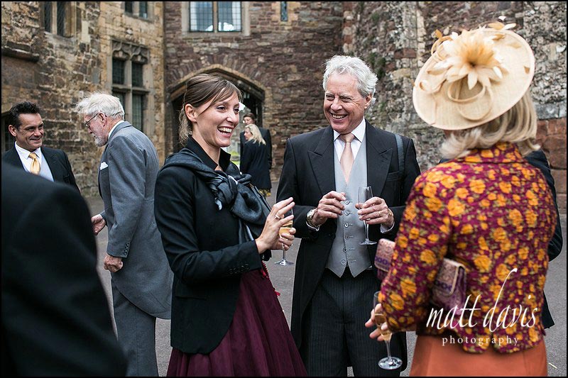 Wedding-photography-Berkeley-Castle-074 Wedding guests in Berkeley Castle courtyard during the drinks reception