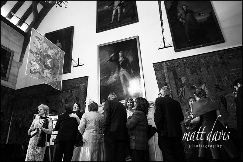 Wedding-at-Berkeley-Castle-058 Wedding guests looking at a wedding table plan during receiving line