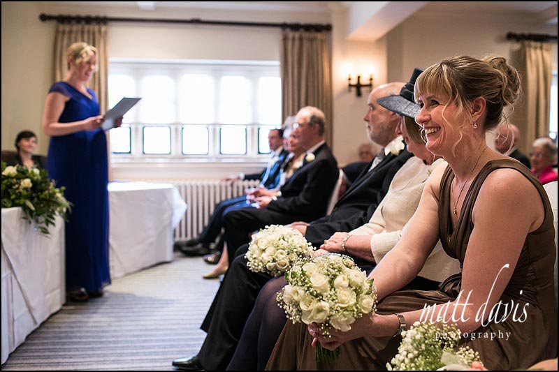 Bridesmaid laughing during wedding ceremony at Manor House Hotel
