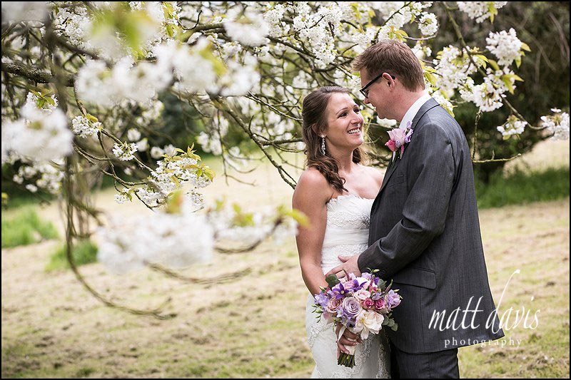 wedding photos taken at Dumbleton Hall in the tree blossom