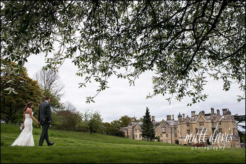 Dumbleton Hall in the background of a couples wedding photos