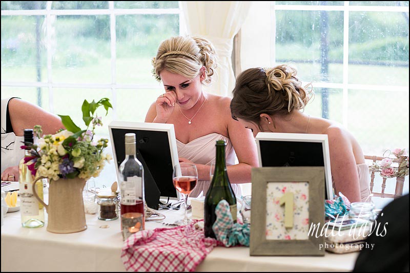 bridesmaid crying as she opens her unique wedding gift