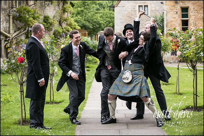 group wedding photo of ushers & best men fighting