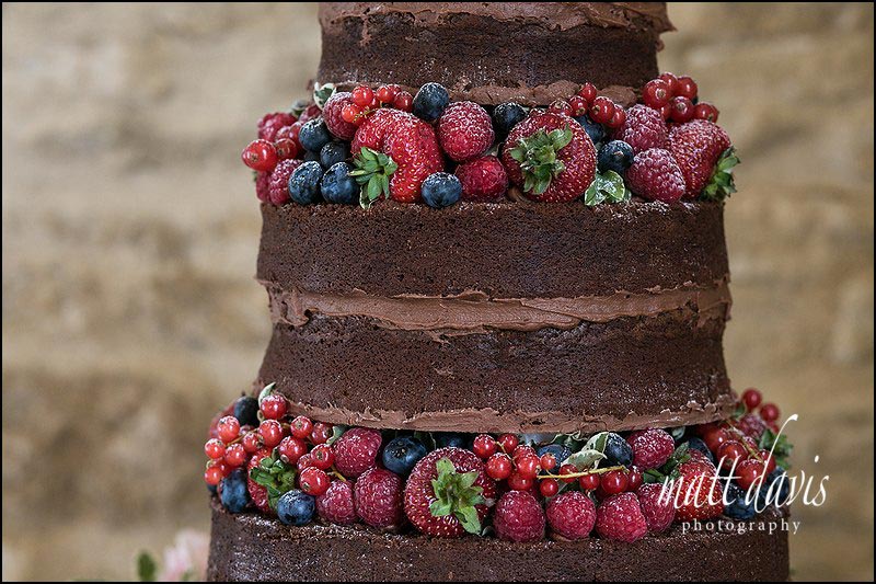 Chocolate wedding cake with fresh fruit in between the layers