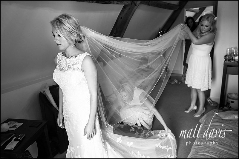Stunning photo of bride in wedding dress with lace straps and long veil