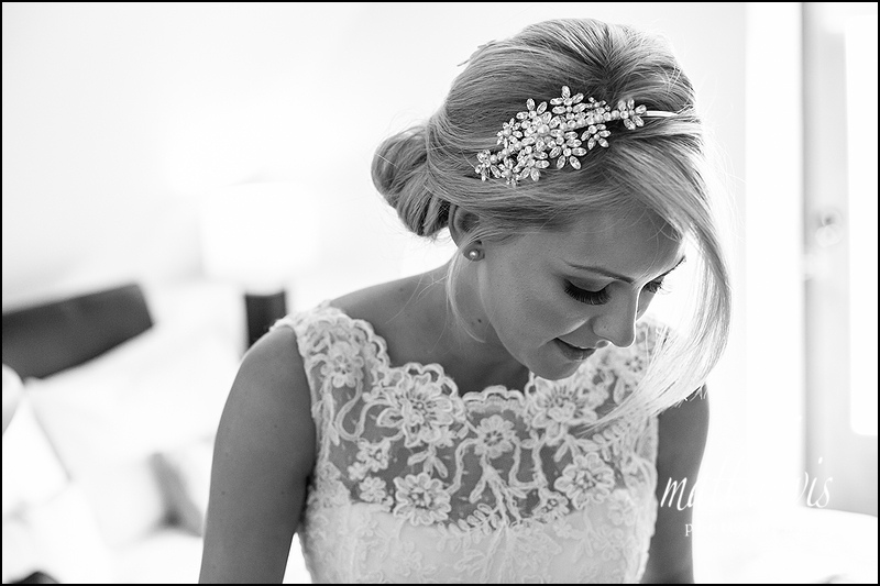 Stunning photo of blonde bride in wedding dress with lace straps and beautiful hair piece 