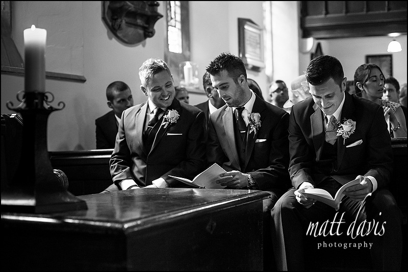 Groom and best man waiting for wedding to start at Kingscote Church, Gloucestershire