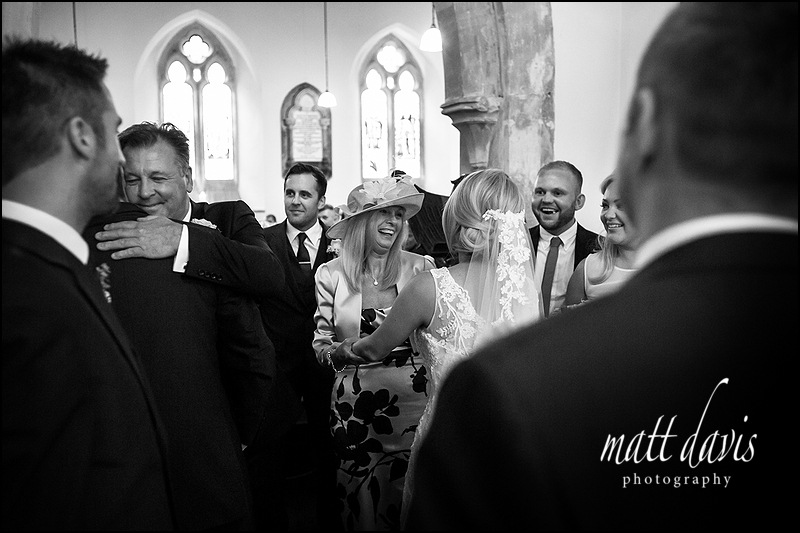black and white documentary photography of a Wedding at Kingscote Church, Gloucestershire