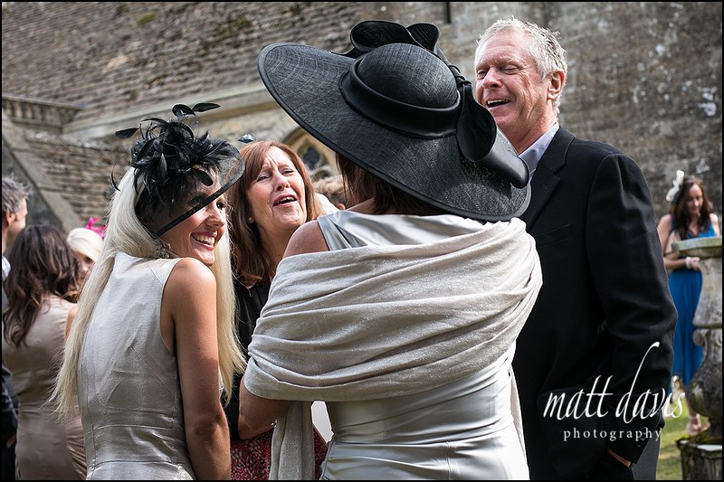wedding guests outside Kingscote Church in Gloucestershire