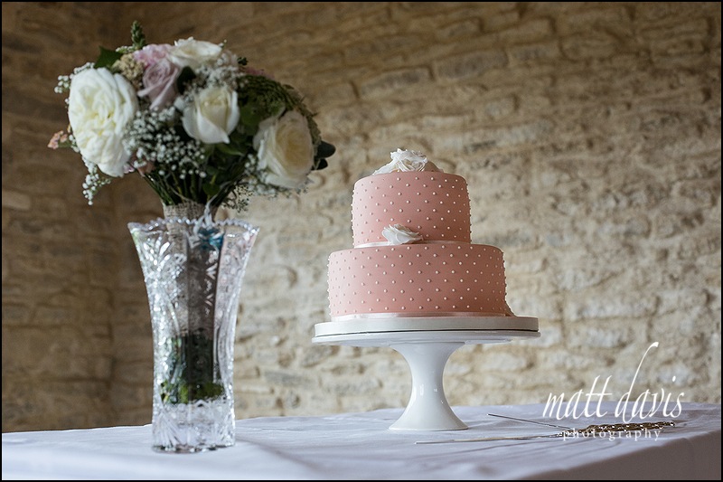 soft pink wedding cake with simple design of cream dots.
