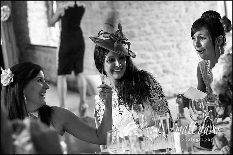 candid moments during wedding speeches at Kingscote barn