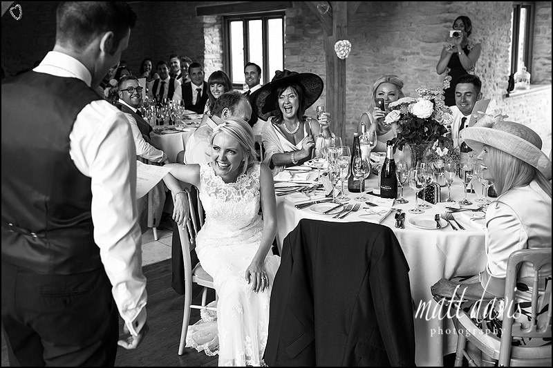 reportage moments photographed in black and white during wedding speeches at Kingscote barn