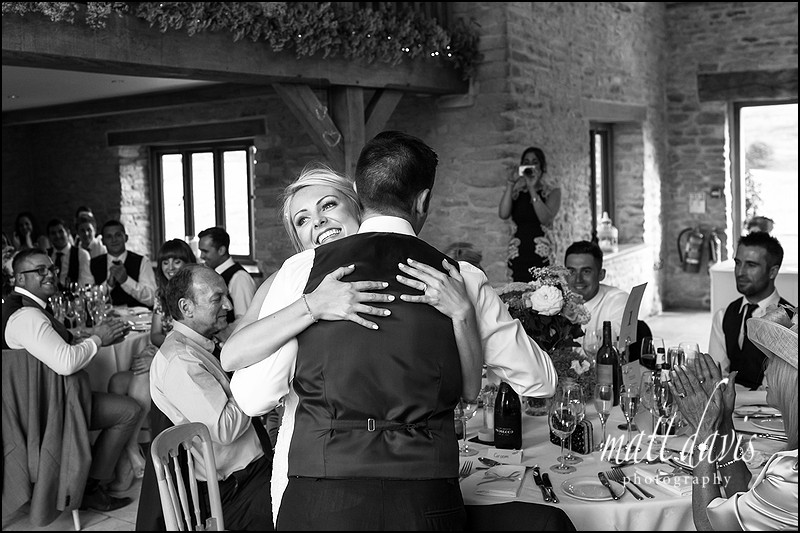 candid moments photographed in black and white during wedding speeches at Kingscote barn