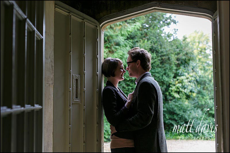 Couple kissing in the doorway at Barnsley House near Cirencester, Gloucestershire