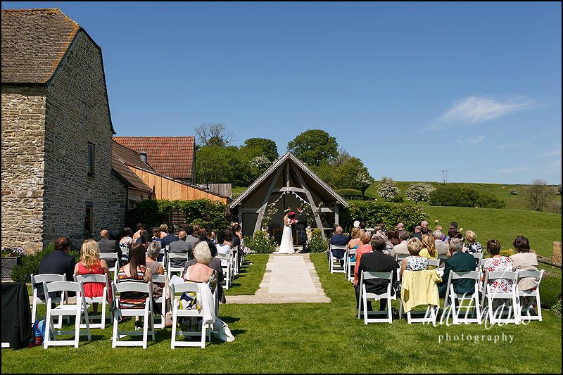 An outdoor wedding at Kingscote Barn