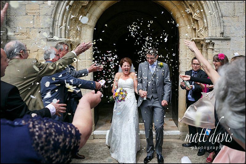 Wedding couple leaving St Michael's & All Angels Church, Bishop's Cleeve, Cheltenham