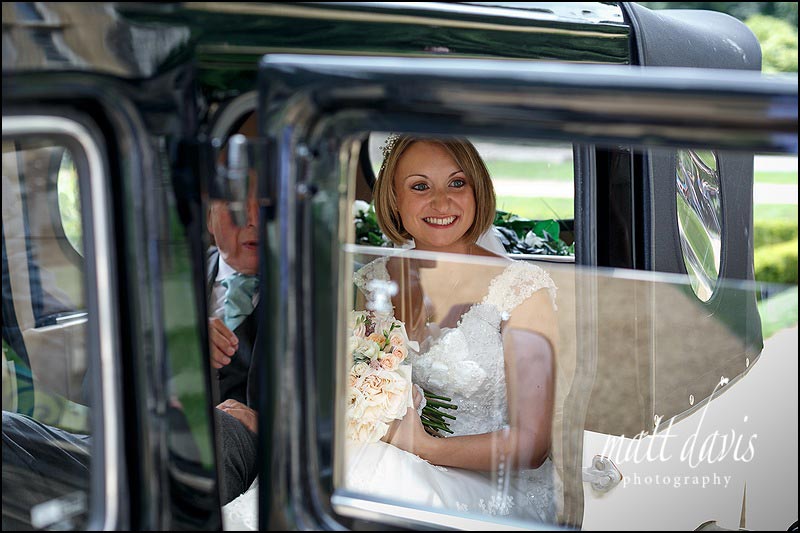 Brides arrival at Highcliffe castle in a vintage car for a wedding